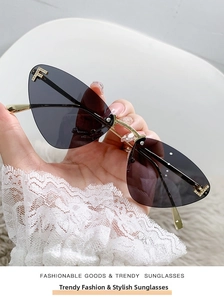 Detail of rimless cat eye sunglasses featuring gold metal temples and rhinestone F logo