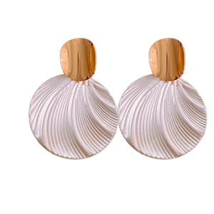 Vintage gold oval studs with white textured shell round drop earrings on white background