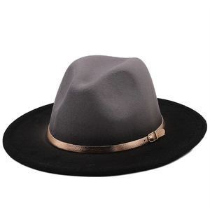 Close-up of dual-tone wool fedora hat with bronze leather band and gold buckle detail