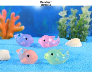 Detailed view of four colorful resin dolphins in a blue sand micro landscape