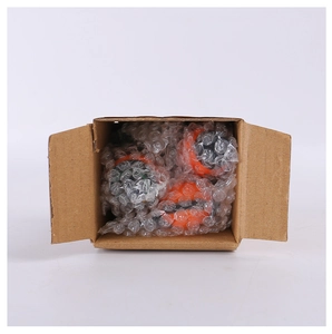 Mini Halloween pumpkin figurines securely packed in a cardboard box with bubble wrap