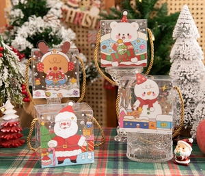 Detailed view of Christmas PVC gift boxes featuring festive cartoon characters and gold handles
