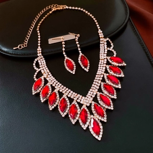 Close-up of gold-plated necklace set with red marquise crystals and white rhinestones