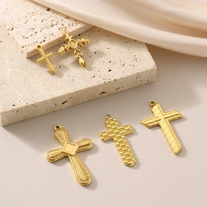 Detailed view of five golden stainless steel cross pendants for DIY jewelry crafting