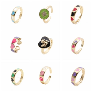 Detailed grid of adjustable gold rings with colorful enamel palm and heart designs