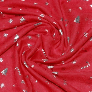 Detail of red Christmas scarf featuring silver foil snowflakes and Xmas tree prints