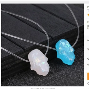 Sparkling resin skull pendants in white and blue with iridescent glitter finish