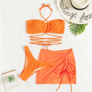 Three-piece bright orange drawstring bikini set with mesh skirt and textured fabric