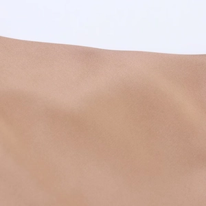 Macro shot of light brown satin fabric texture with fine twill weave and elegant luster