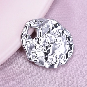 Close-up of irregular 304 stainless steel pendant with textured lava finish
