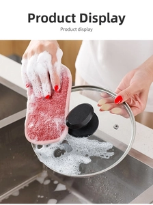 Dual-sided pink kitchen sponge creating rich foam on a glass lid for deep cleaning