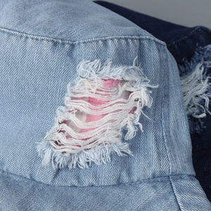 Light blue denim bucket hat with distressed ripped detail and pink striped lining pattern