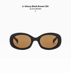 Detail view of retro oval sunglasses featuring glossy black frames and tea brown lenses