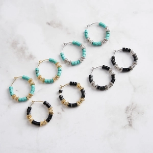 Vintage S925 silver hoop earrings with obsidian and turquoise beads on marble surface