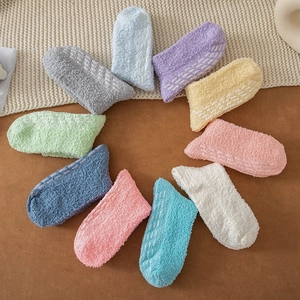 Detail view of multi-color coral fleece socks with anti-slip silicone dots on sole