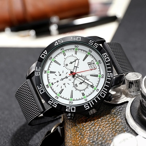 Macro side view of men's sports chronograph watch with luminous markers and mesh strap