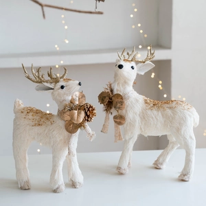White plush Christmas reindeer figures with gold glitter antlers and pinecone neck decor