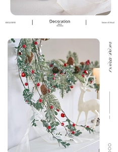 Close-up of Christmas rattan garland with red berries and pine cones on white background