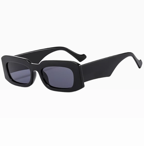 Detail of vintage rectangular sunglasses with glossy black wide frame and dark grey lenses