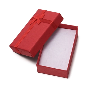 Detailed view of red rectangular jewelry gift box with ribbon bow and white sponge foam
