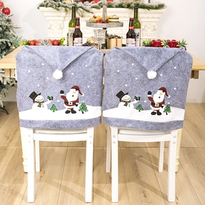 Christmas chair covers featuring grey Santa and Snowman prints with white pom-pom tops