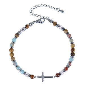 Detail of colorful natural stone beaded bracelet with metal cross and silver lobster clasp