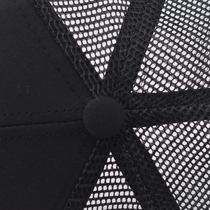 Detailaufnahme der atmungsaktiven schwarzen Mesh-Trucker-Kappe mit verstärktem Knopf