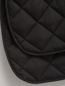 Close-up of black diamond-quilted nylon fabric texture and neat stitching on padded coat