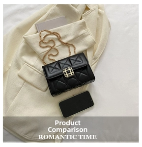 Detailed top view of black quilted crossbody bag with gold chain and vintage buckle