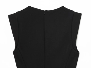 Detail of black romper back neckline with smooth fabric and a functional hidden zipper