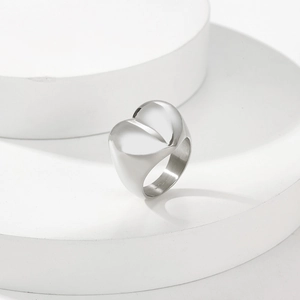 Detailed view of heart-shaped wide band ring with mirror polished silver finish