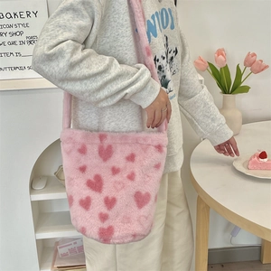 Detailed close-up of pink plush bucket bag featuring soft fuzzy texture and heart patterns
