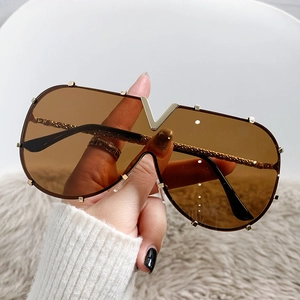 Oversized shield sunglasses with brown lenses and golden V-shaped metal decoration