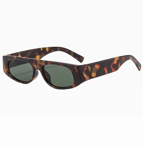 Macro view of tortoise shell frame and deep green lenses on rectangular sunglasses