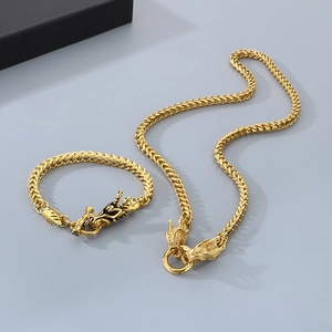 Detailed macro view of the golden dragon head clasp on a Franco style chain bracelet