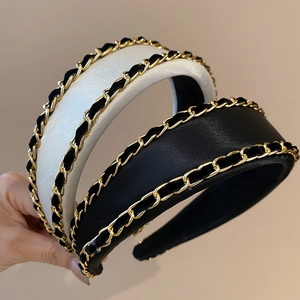 Detailed macro view of the woven gold metal chain and satin fabric on the headband