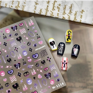 Macro shot of M-1114 Y2K nail art stickers featuring gothic heart and flame designs