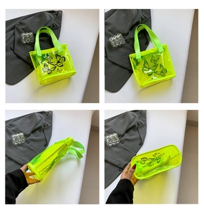 Detail of neon green transparent PVC tote bag with butterfly print and nylon handles