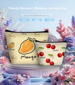 Detail view of mango and cherry patterned cosmetic bags with zipper closure and layering