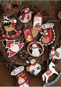 Rustic Christmas painted wood ornaments with Santa and snowman details on twine