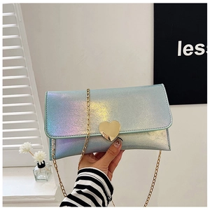 Detail of light blue iridescent glitter handbag with heart-shaped gold metal clasp lock