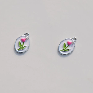 Detailed macro view of oval tulip flower pendants with pink hearts and white pearls