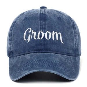 Macro detail of white Groom embroidery on navy washed cotton vintage baseball cap