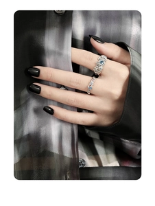 Close-up of S925 silver rings with blue zircon and irregular pleated design on hand