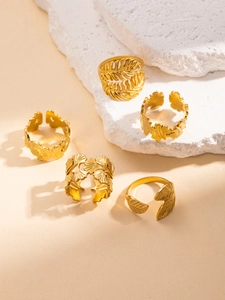 Set of five gold titanium steel rings with botanical leaves and adjustable open design