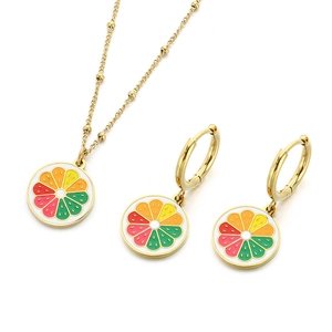 Golden citrus necklace and earrings set with colorful enamel fruit slices on white background