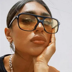 Retro pilot sunglasses with black frames, yellow lenses, and signature T-shaped metal hinges