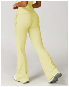 Detail view of high waisted yoga flare pants with ruched side drawstring in light yellow
