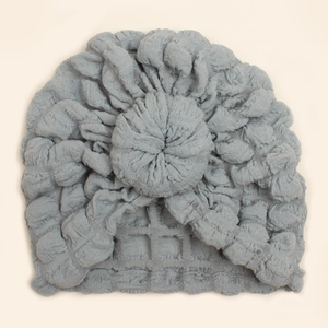 Close-up of light blue baby donut turban hat with soft bubble texture fabric and knot
