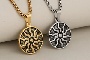 Close-up of vintage punk sun god pendants in gold and silver with pearl box chains
